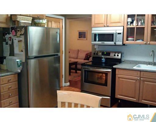 3046 Cheesequake Road Old Bridge, NJ 08859 - Photo 14 of 16 a kitchen with a refrigerator stove and microwave