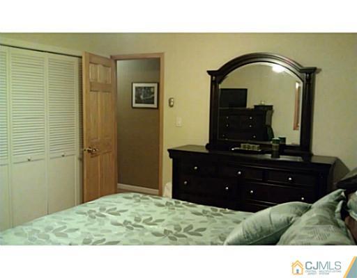 3046 Cheesequake Road Old Bridge, NJ 08859 - Photo 9 of 16 a bedroom with a bed and a mirror on dresser