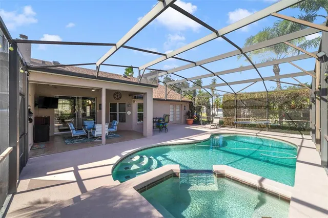 a living room with furniture kitchen view and a flat screen tv