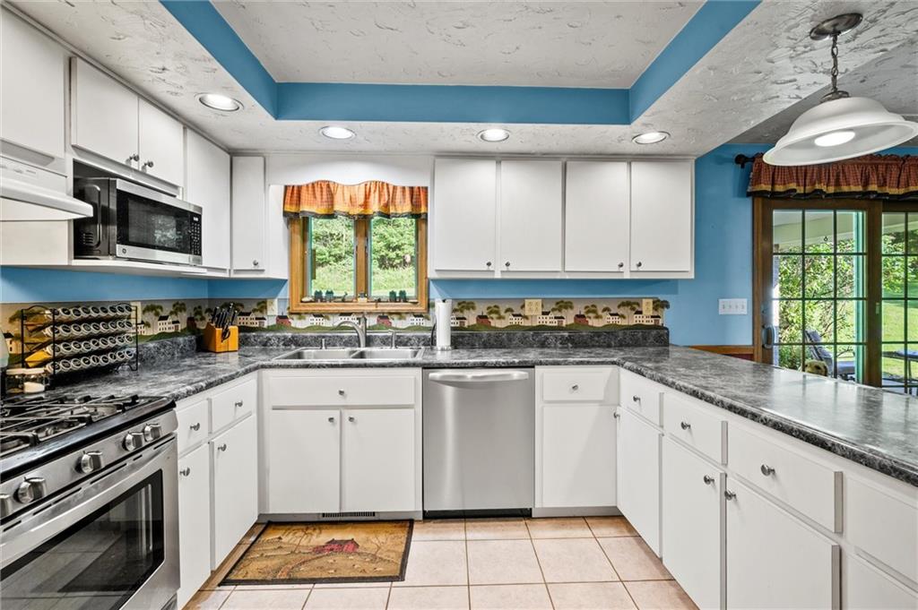 206 Harbison Road Sarver, PA 16055 - Photo 7 of 46 a kitchen with stainless steel appliances granite countertop a stove a sink and a microwave