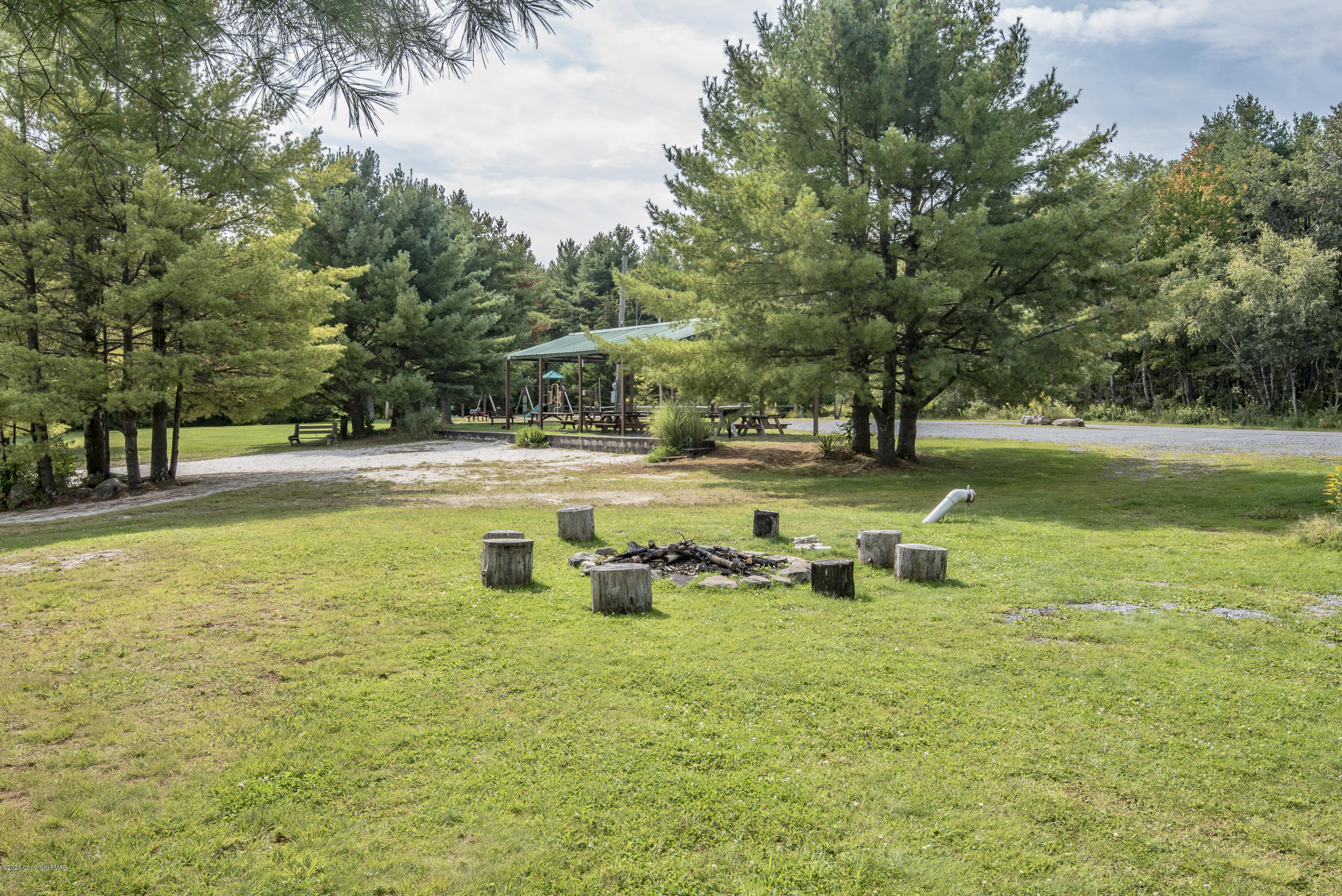 39 Lidio Road Blakeslee, PA 18610 - Photo 12 of 14 a view of a swimming pool with lawn chairs under an umbrella