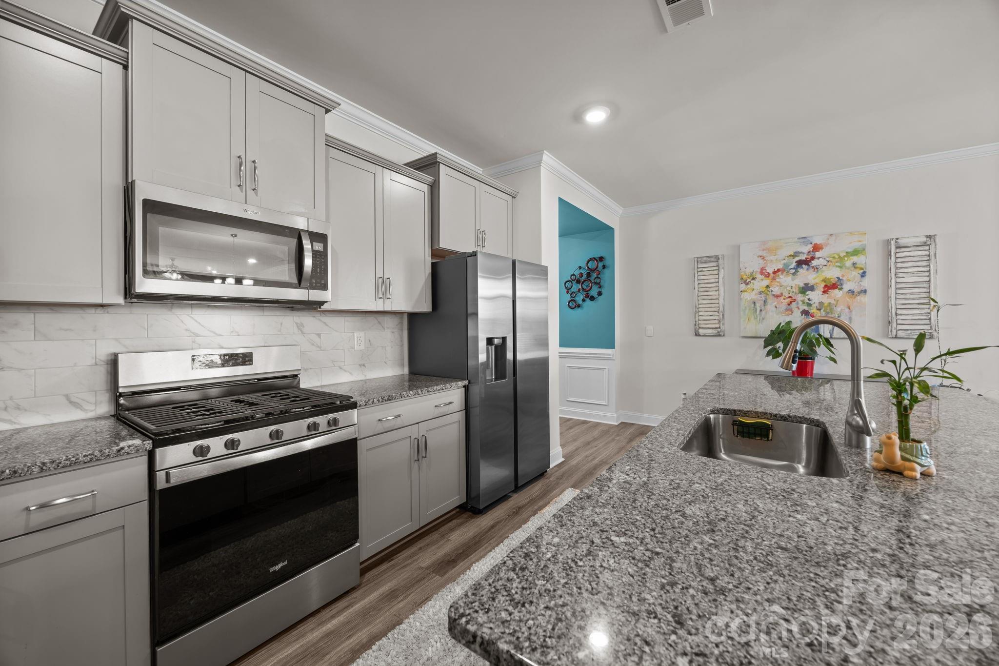 7895 Iron Road Sherrills Ford, NC 28673 - Photo 11 of 38 a kitchen with stainless steel appliances granite countertop a stove a microwave a refrigerator and cabinets