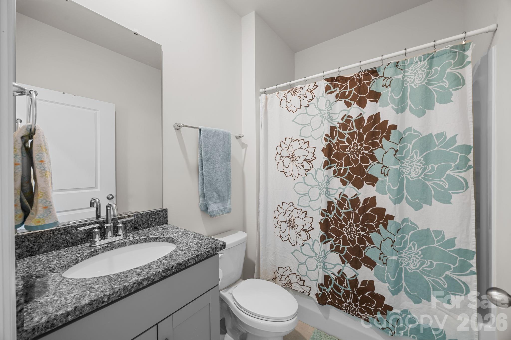 7895 Iron Road Sherrills Ford, NC 28673 - Photo 18 of 38 a bathroom with a granite countertop sink toilet and shower