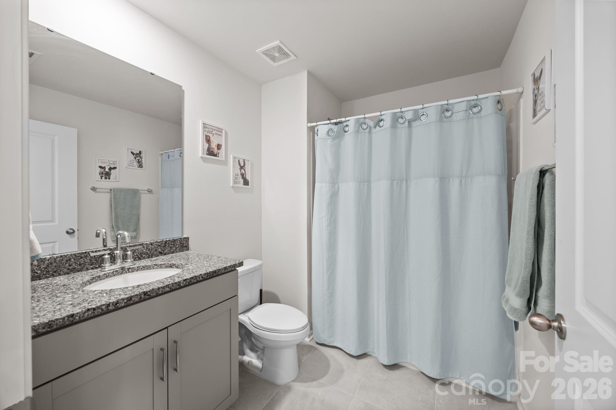 7895 Iron Road Sherrills Ford, NC 28673 - Photo 23 of 38 a bathroom with a granite countertop sink toilet and a mirror