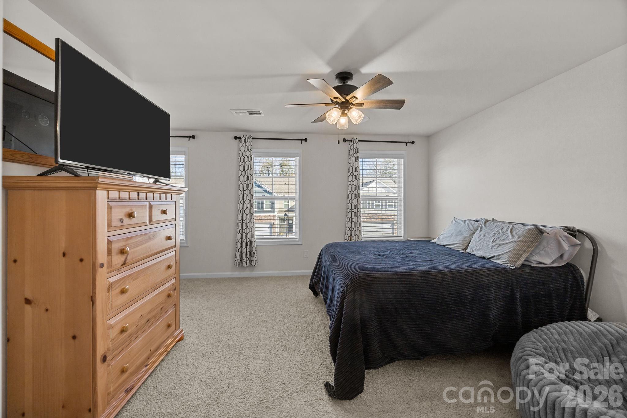 7895 Iron Road Sherrills Ford, NC 28673 - Photo 24 of 38 a bedroom with a bed and a flat tv screen on dresser