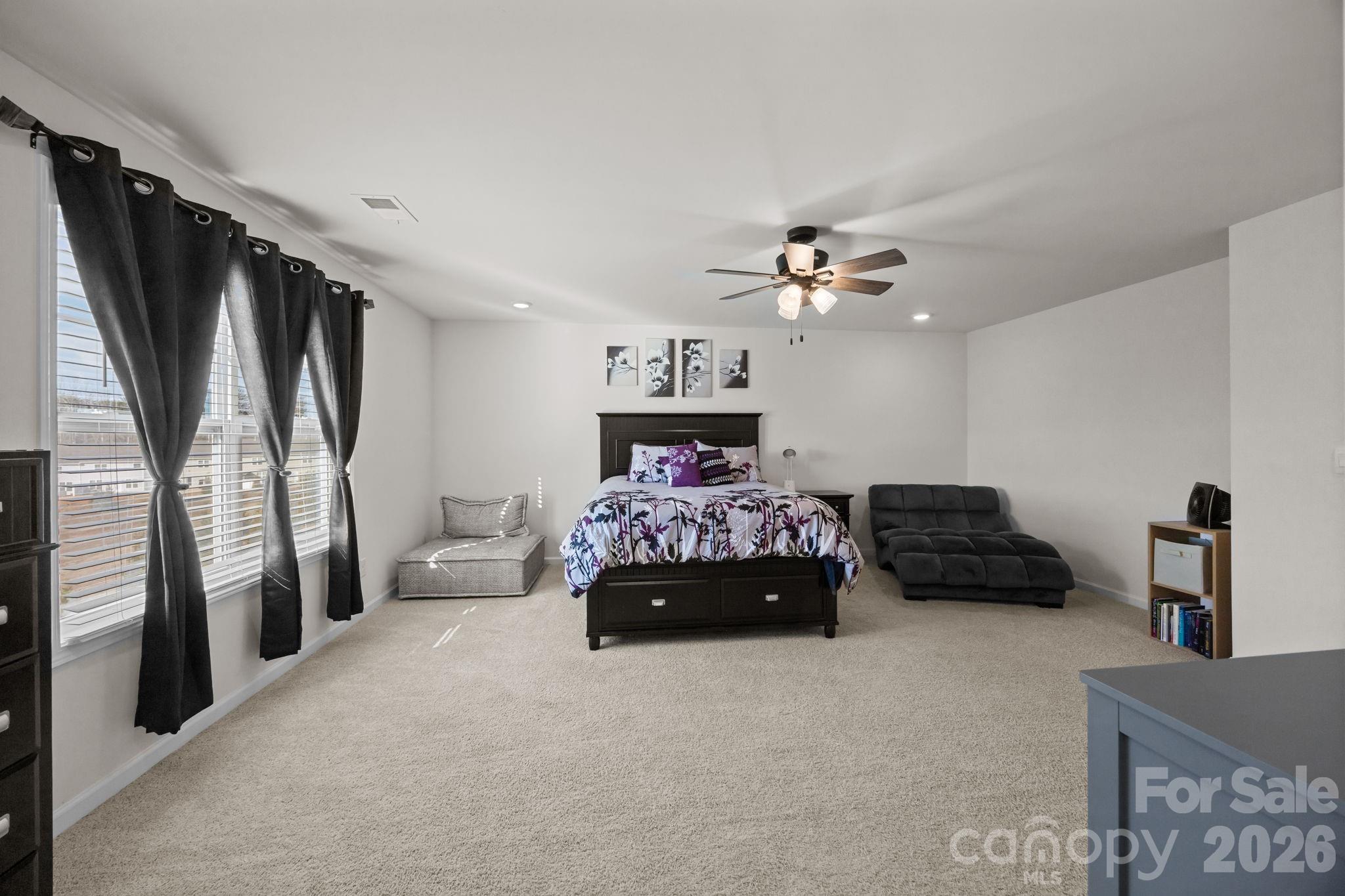 7895 Iron Road Sherrills Ford, NC 28673 - Photo 27 of 38 a bedroom with furniture and a chandelier