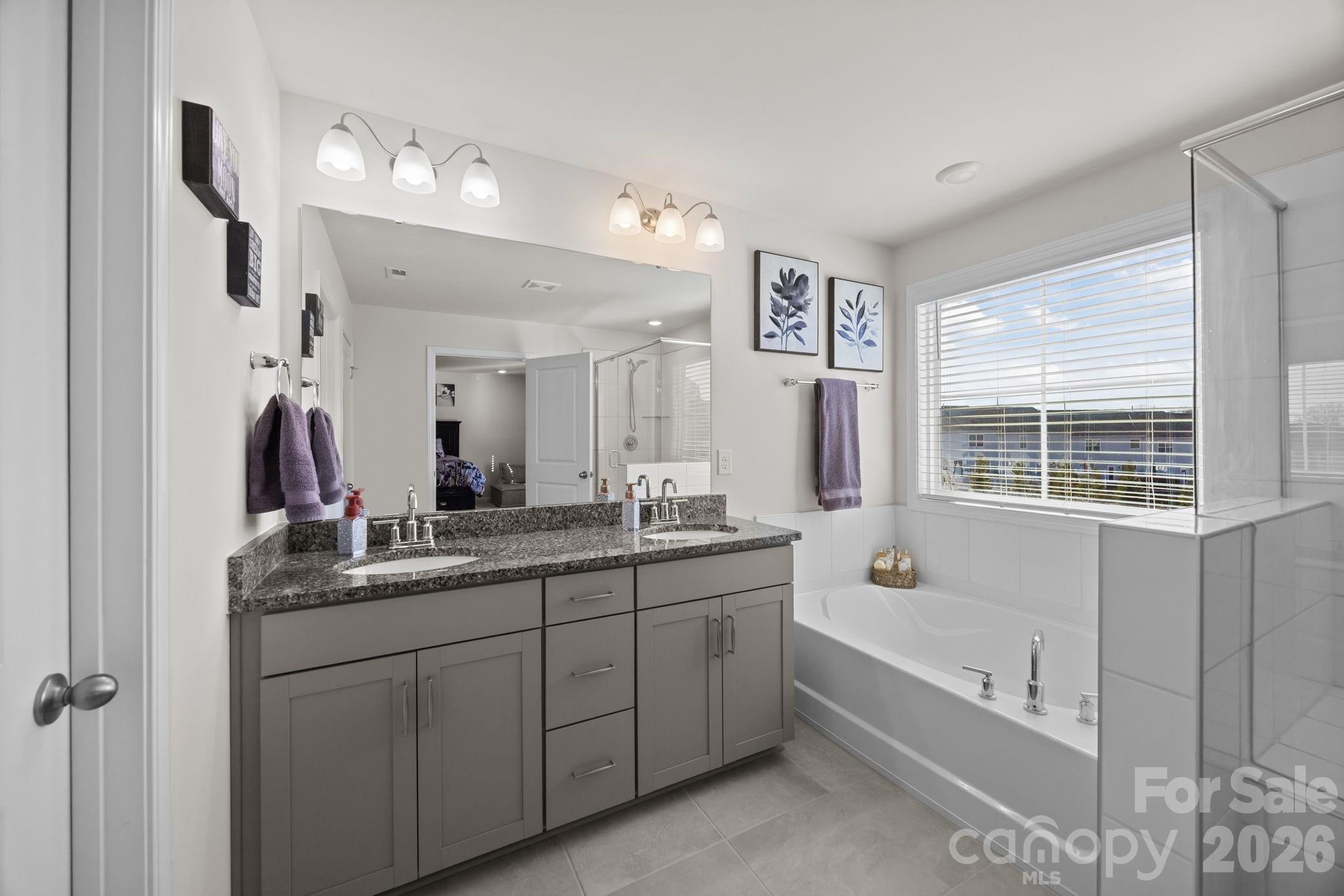 7895 Iron Road Sherrills Ford, NC 28673 - Photo 28 of 38 a bathroom with a tub sink double vanity granite and shower