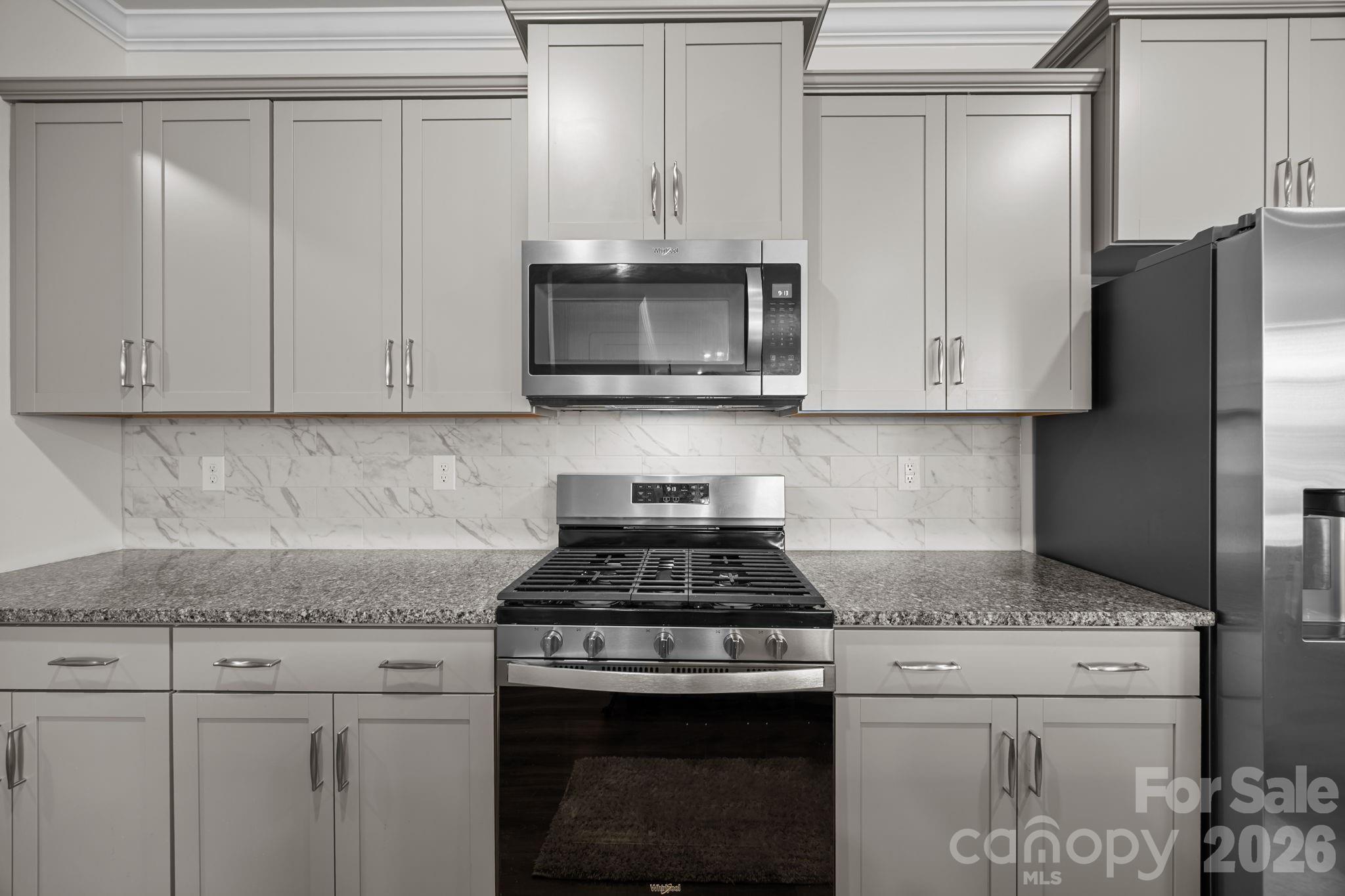 7895 Iron Road Sherrills Ford, NC 28673 - Photo 9 of 38 a kitchen with granite countertop white cabinets and a stove top oven
