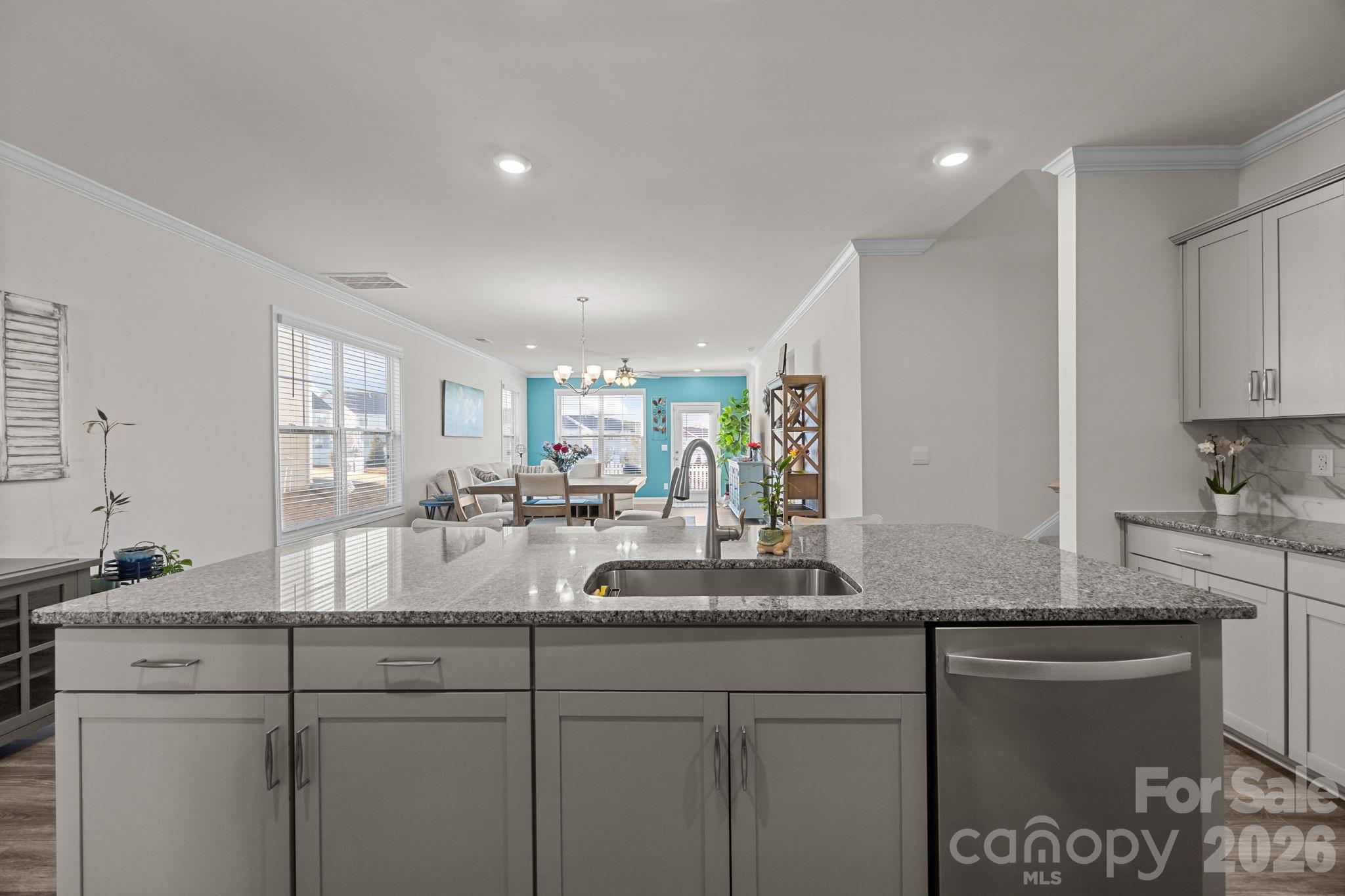 7895 Iron Road Sherrills Ford, NC 28673 - Photo 10 of 38 a kitchen with kitchen island granite countertop a sink and white cabinets