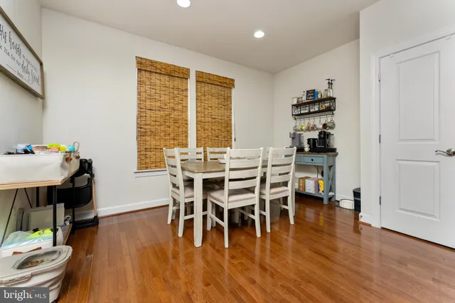 a dining room with furniture window and wooden floor
