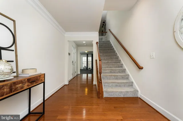 a view of a hallway with entryway wooden floor and front door