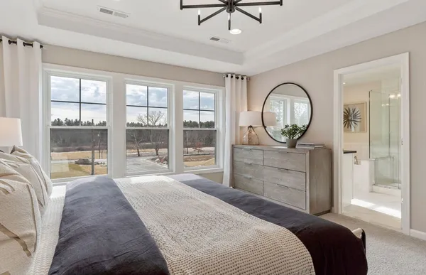 a bedroom with a large bed and a large window
