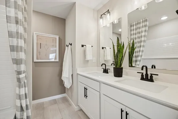 a bathroom with a shower sink and mirror
