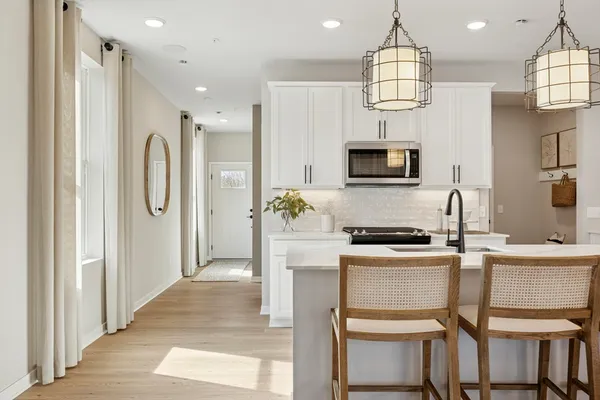a kitchen with cabinets and stainless steel appliances