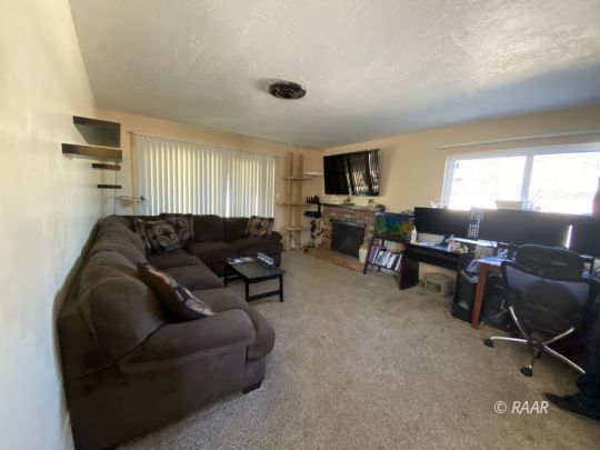 413 Karin Street Ridgecrest, CA 93555 - Photo 2 of 20 a living room with furniture and a flat screen tv