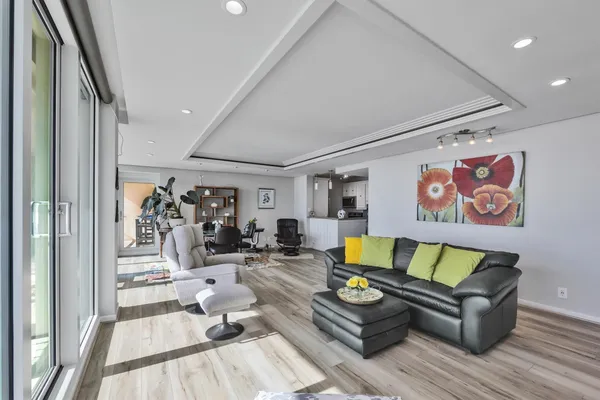 a living room with furniture and wooden floor