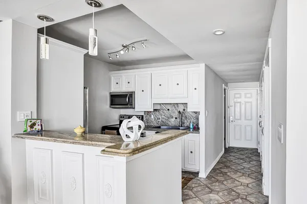a kitchen with stainless steel appliances granite countertop a sink and cabinets