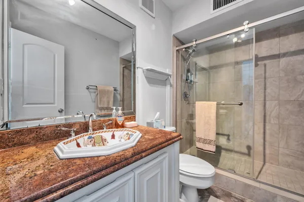 a bathroom with a sink toilet and shower