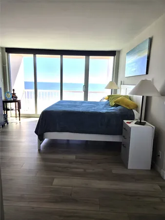 a spacious bedroom with a large bed and a large window