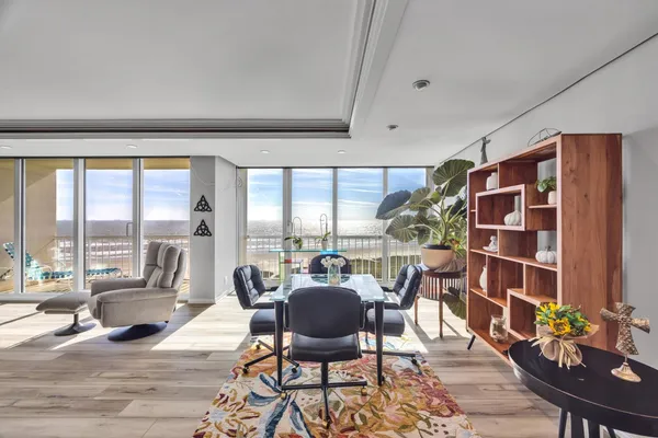 a view of a livingroom with furniture and floor to ceiling window
