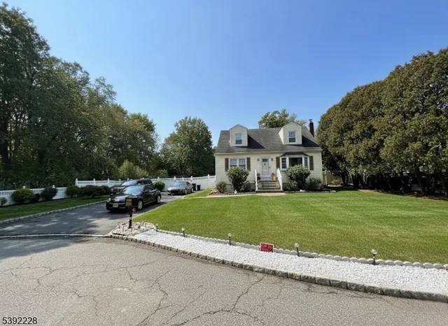 a front view of a house with a garden and pathway
