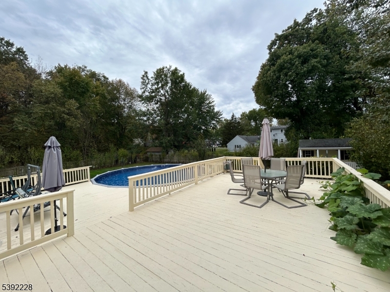 63 Grant Avenue East Hanover, NJ 07936 - Photo 18 of 19 a view of deck with furniture and trees