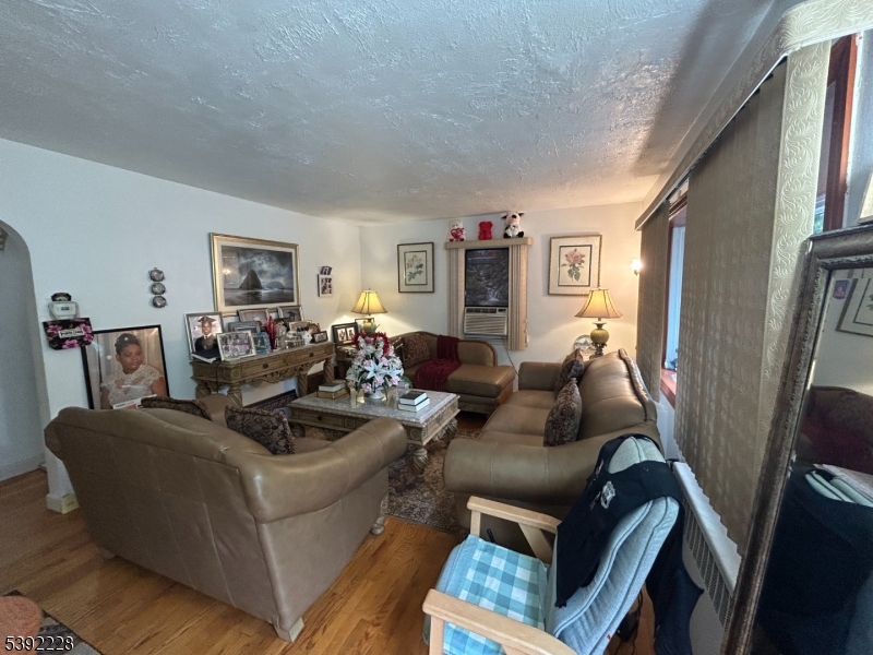 63 Grant Avenue East Hanover, NJ 07936 - Photo 2 of 19 a living room with furniture and a flat screen tv