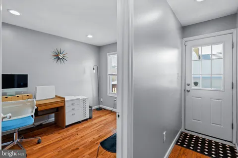 a view of a workspace with furniture and a window