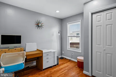 a view of a workspace with furniture and a flat screen tv