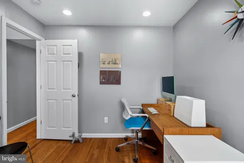 a workspace with furniture and wooden floor