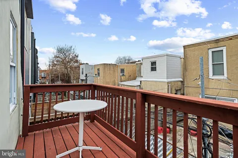 a view of a balcony with a table and chairs