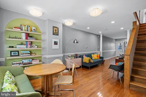 a room with furniture pool table and wooden floor