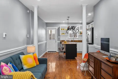 a living room with furniture and wooden floor