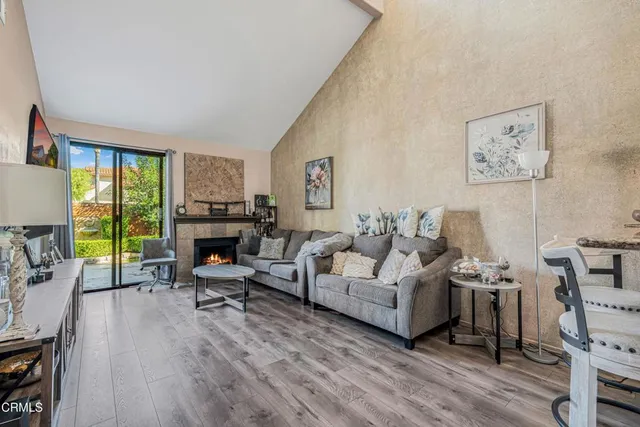 a living room with furniture a fireplace and a flat screen tv