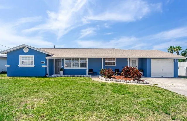 a view of a house with backyard sitting area and garden