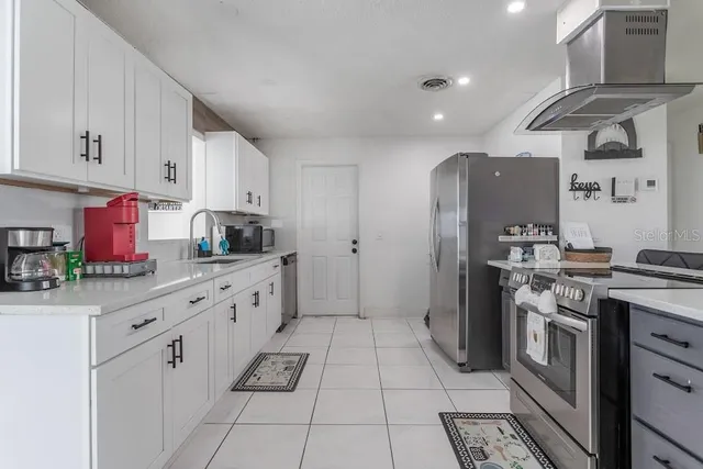 a kitchen with stainless steel appliances granite countertop a sink and cabinets