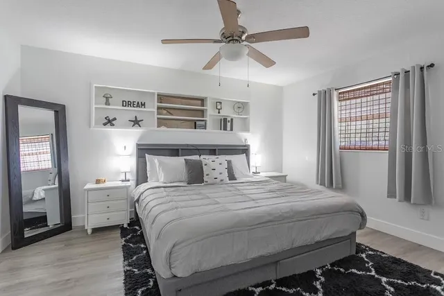 a bedroom with a bed and a chandelier