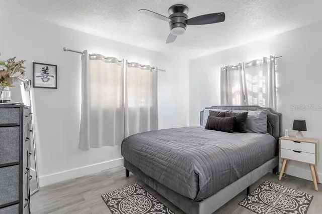 a bedroom with a large bed and a window