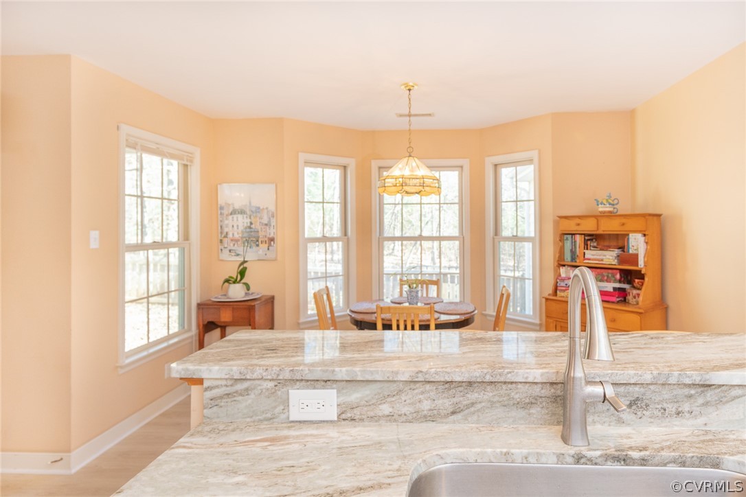 1841 Covington Road Crozier, VA 23039 - Photo 27 of 50 a living room with a large window and chandelier