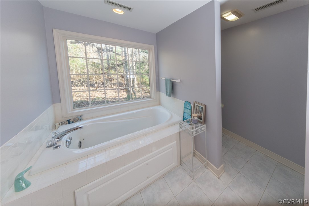 1841 Covington Road Crozier, VA 23039 - Photo 31 of 50 a white bath tub sitting in a bathroom next to a window