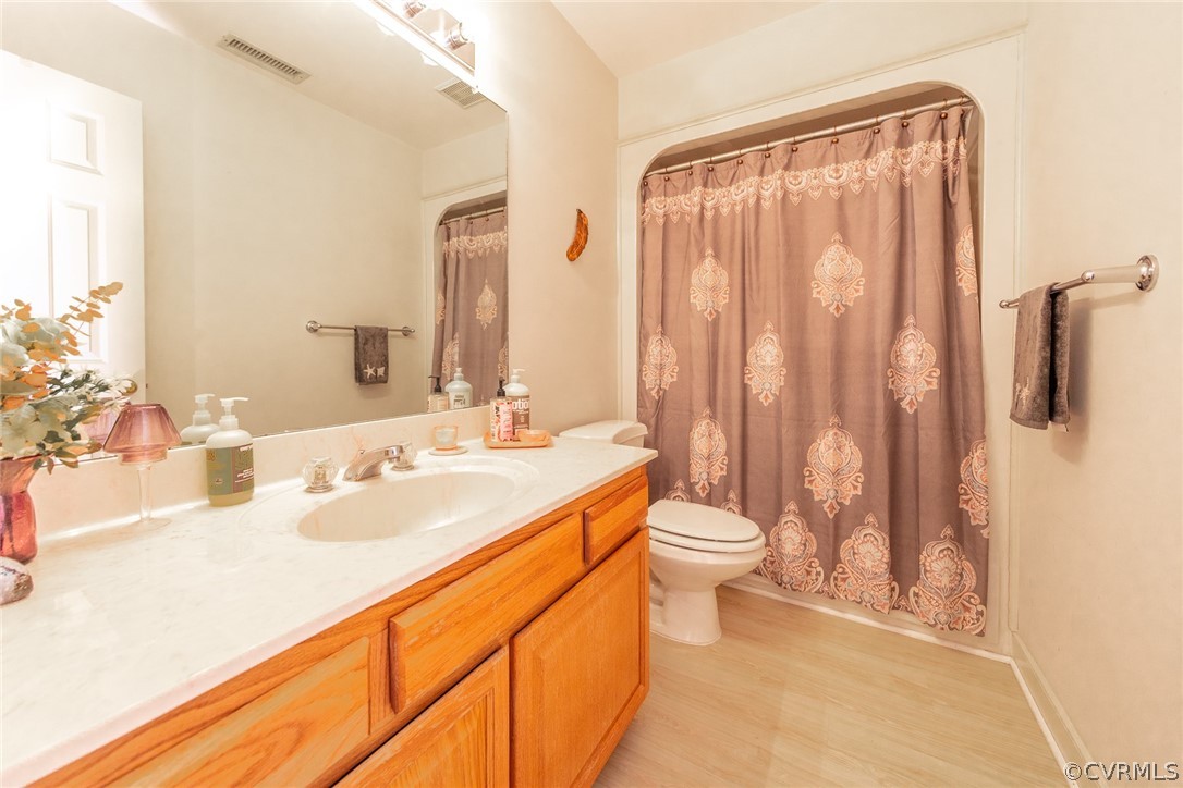 1841 Covington Road Crozier, VA 23039 - Photo 37 of 50 a bathroom with double vanity sinks a toilet a mirror and shower