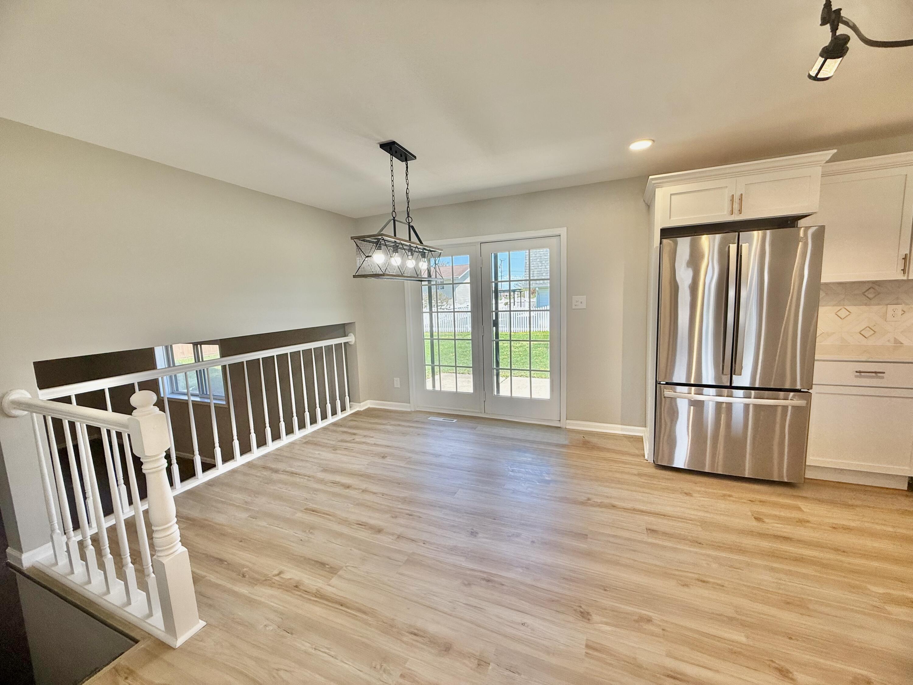 601 Holly Lane Griffith, IN 46319 - Photo 11 of 44 a view of a livingroom with wooden floor and staircase