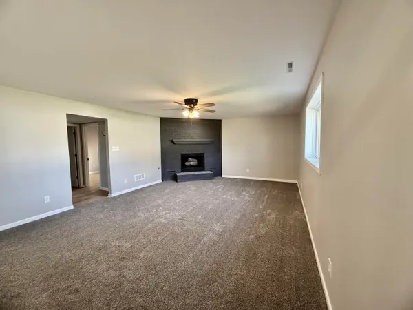 a view of empty room with a fireplace