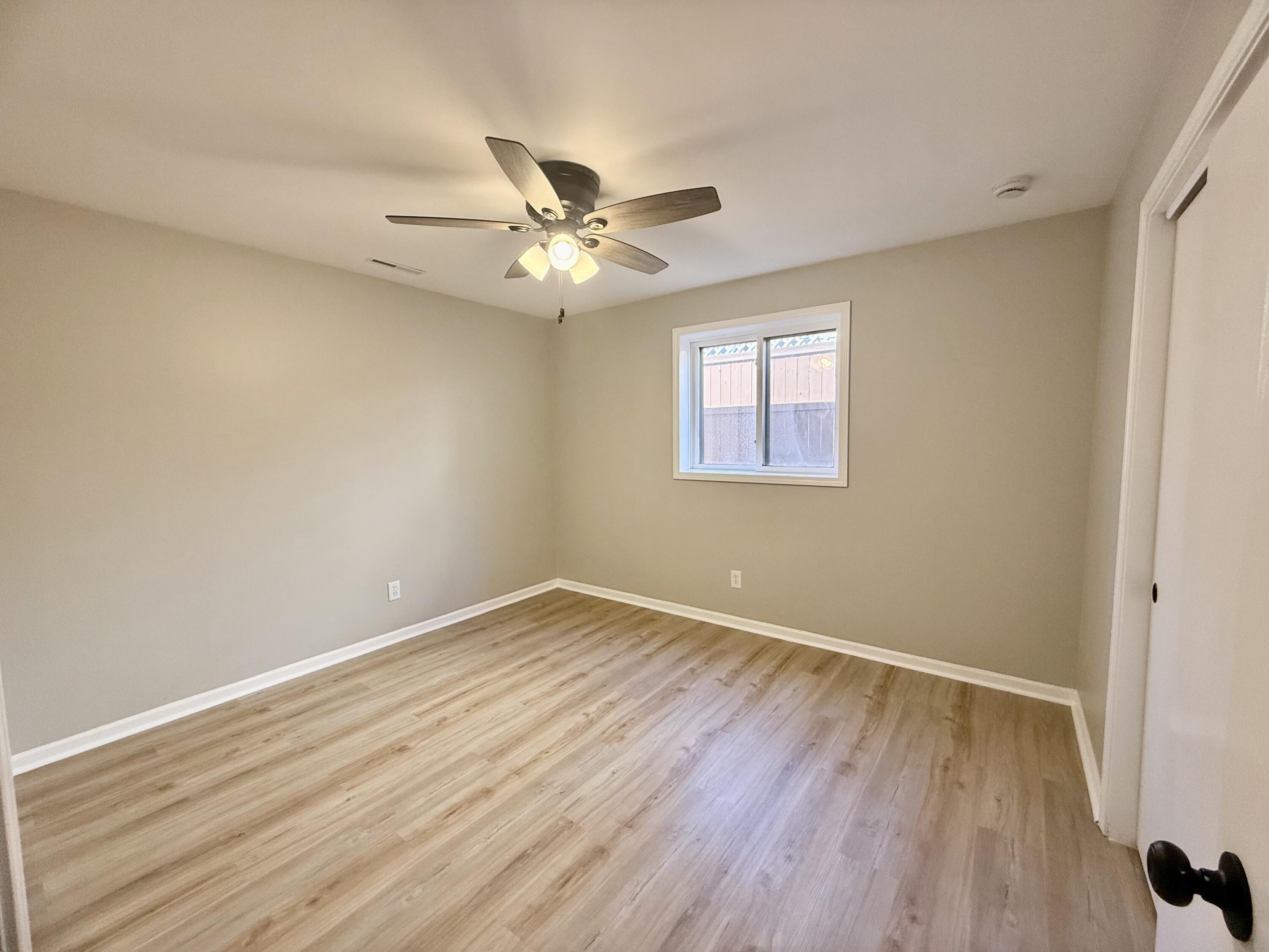 601 Holly Lane Griffith, IN 46319 - Photo 18 of 44 a view of empty room with wooden floor and fan