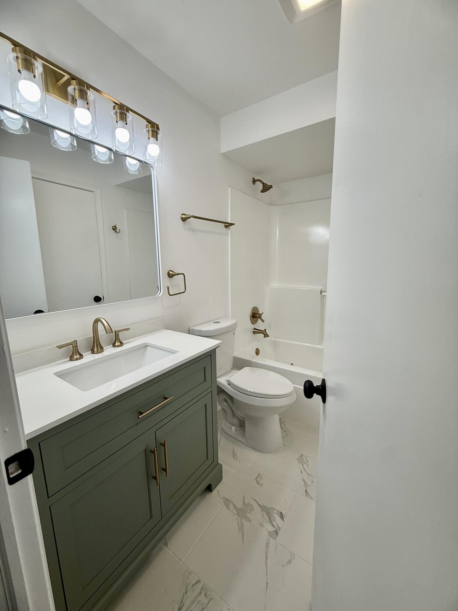 601 Holly Lane Griffith, IN 46319 - Photo 25 of 44 a bathroom with a sink double vanity and mirror
