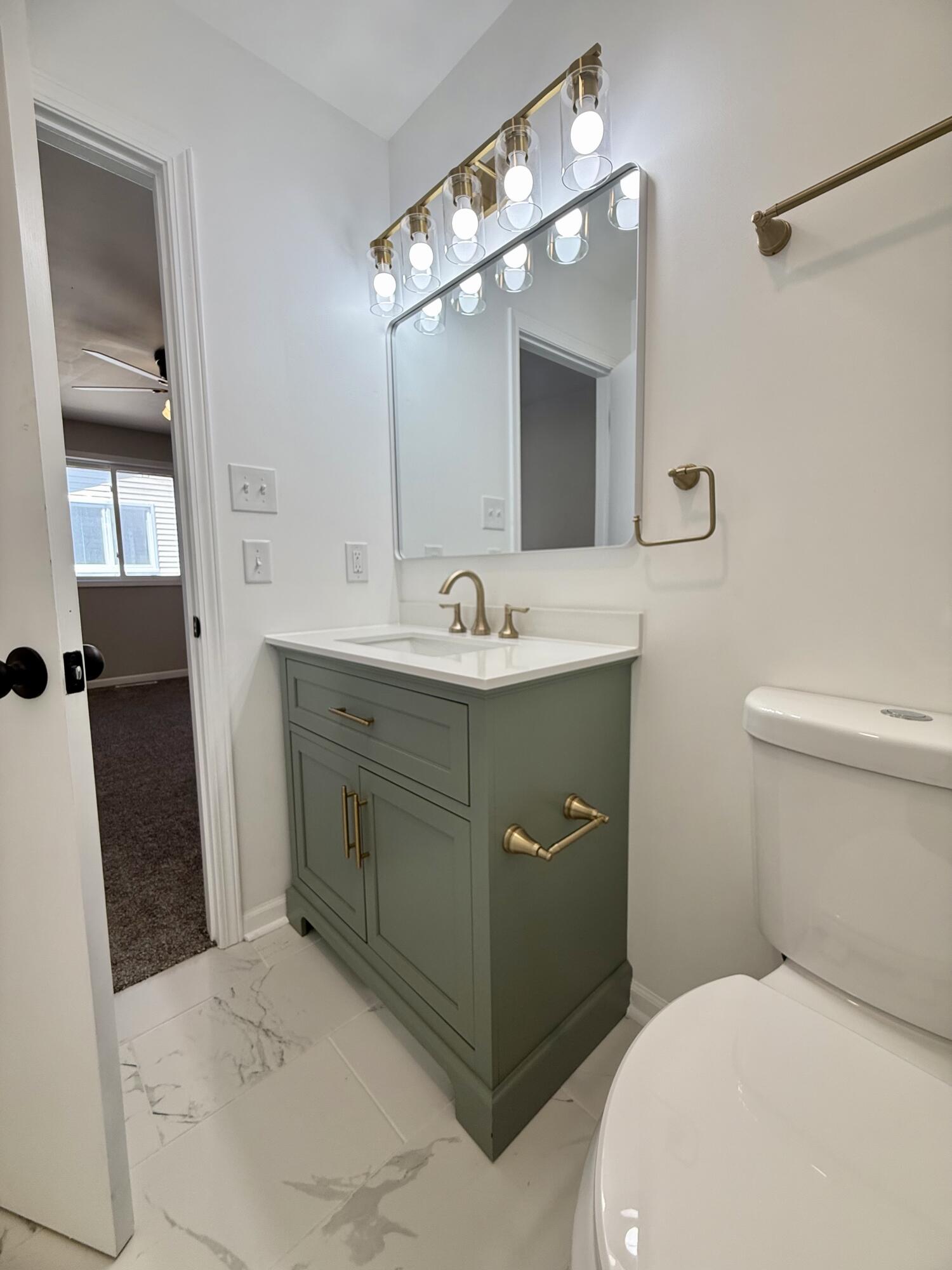 601 Holly Lane Griffith, IN 46319 - Photo 26 of 44 a bathroom with a sink and a mirror