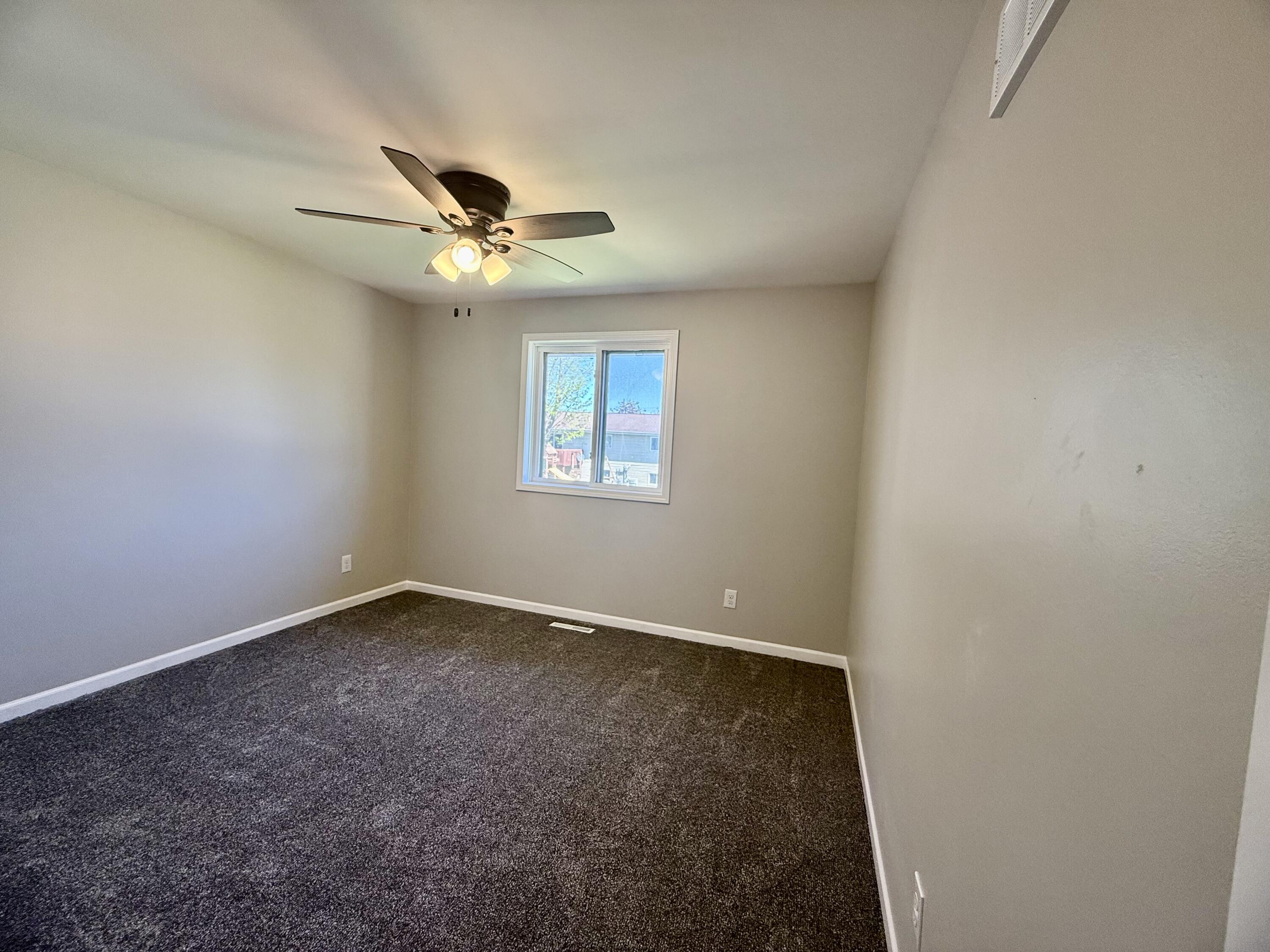 601 Holly Lane Griffith, IN 46319 - Photo 30 of 44 an empty room with a window and a fan