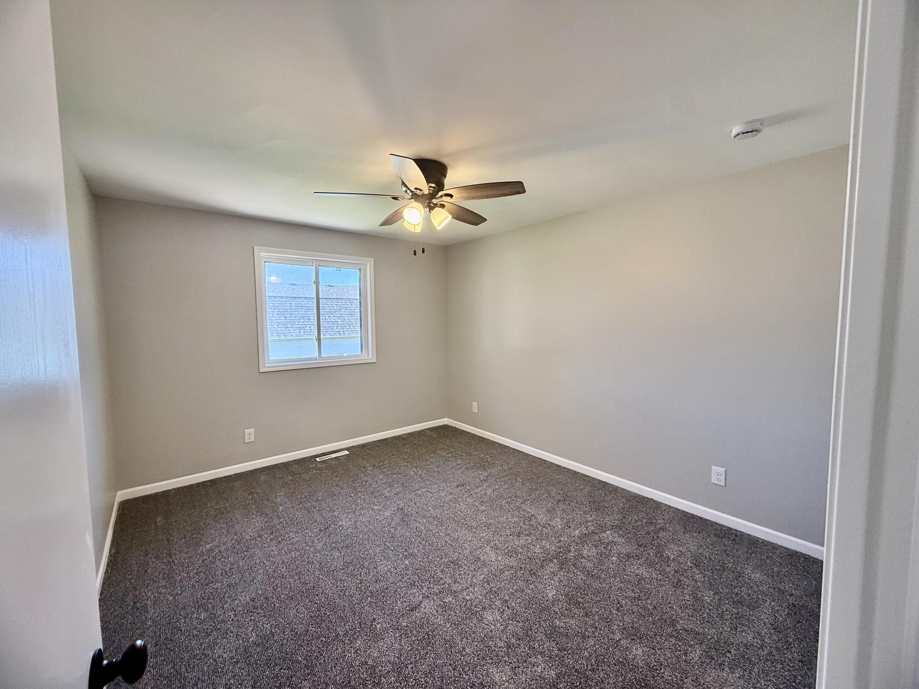 601 Holly Lane Griffith, IN 46319 - Photo 31 of 44 an empty room with a window and a ceiling fan
