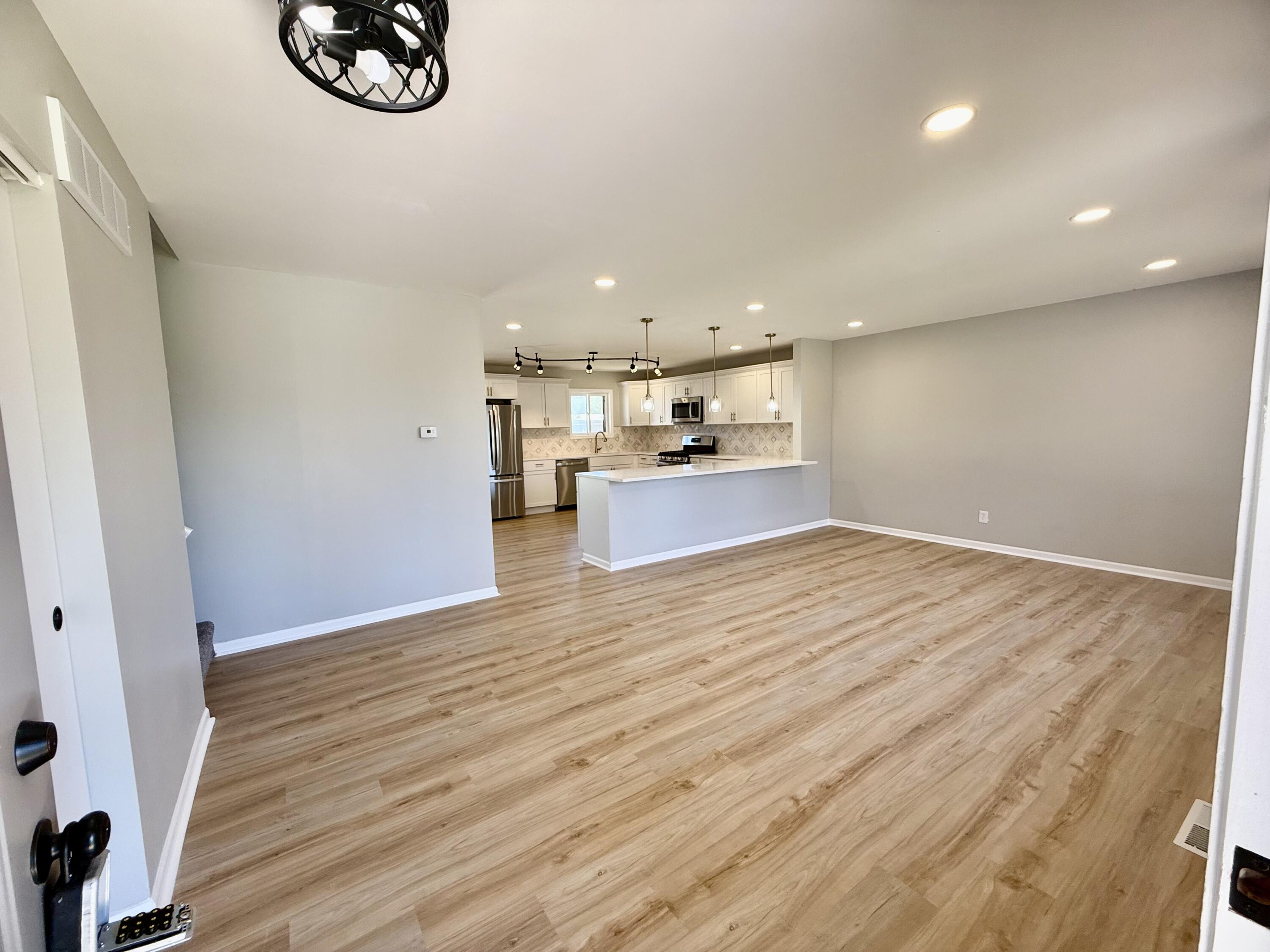 601 Holly Lane Griffith, IN 46319 - Photo 4 of 44 an empty room with wooden floor and windows