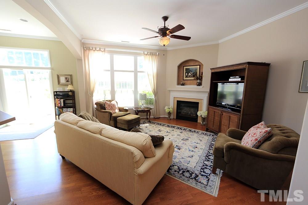 6822 Middleboro Drive Raleigh, NC 27612 - Photo 3 of 13 a living room with furniture a window and a fireplace